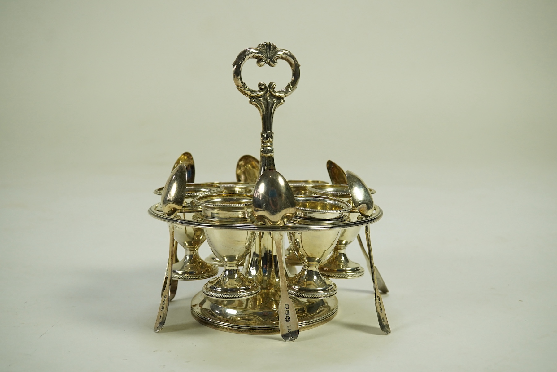 A George III silver egg cruet stand, with six egg cups and six spoons (one not matching), by Solomon Royes & John East Dix